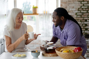 supported living in porthcawl. African social worker helping a senior woman
