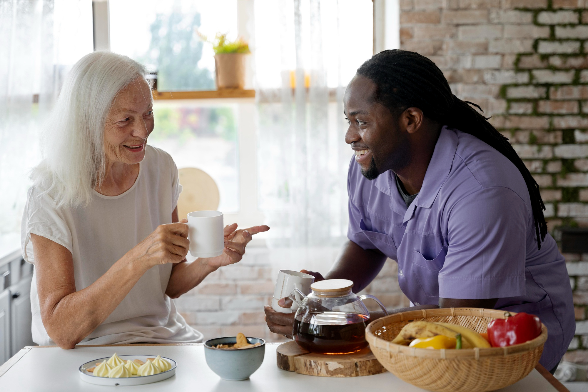 supported living in porthcawl. African social worker helping a senior woman